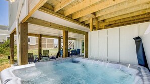 A hot tub under a wooden pergola with chairs around it. - A Salty Pause | 50 ft to the beach | Hot Tub (Kitty Hawk)