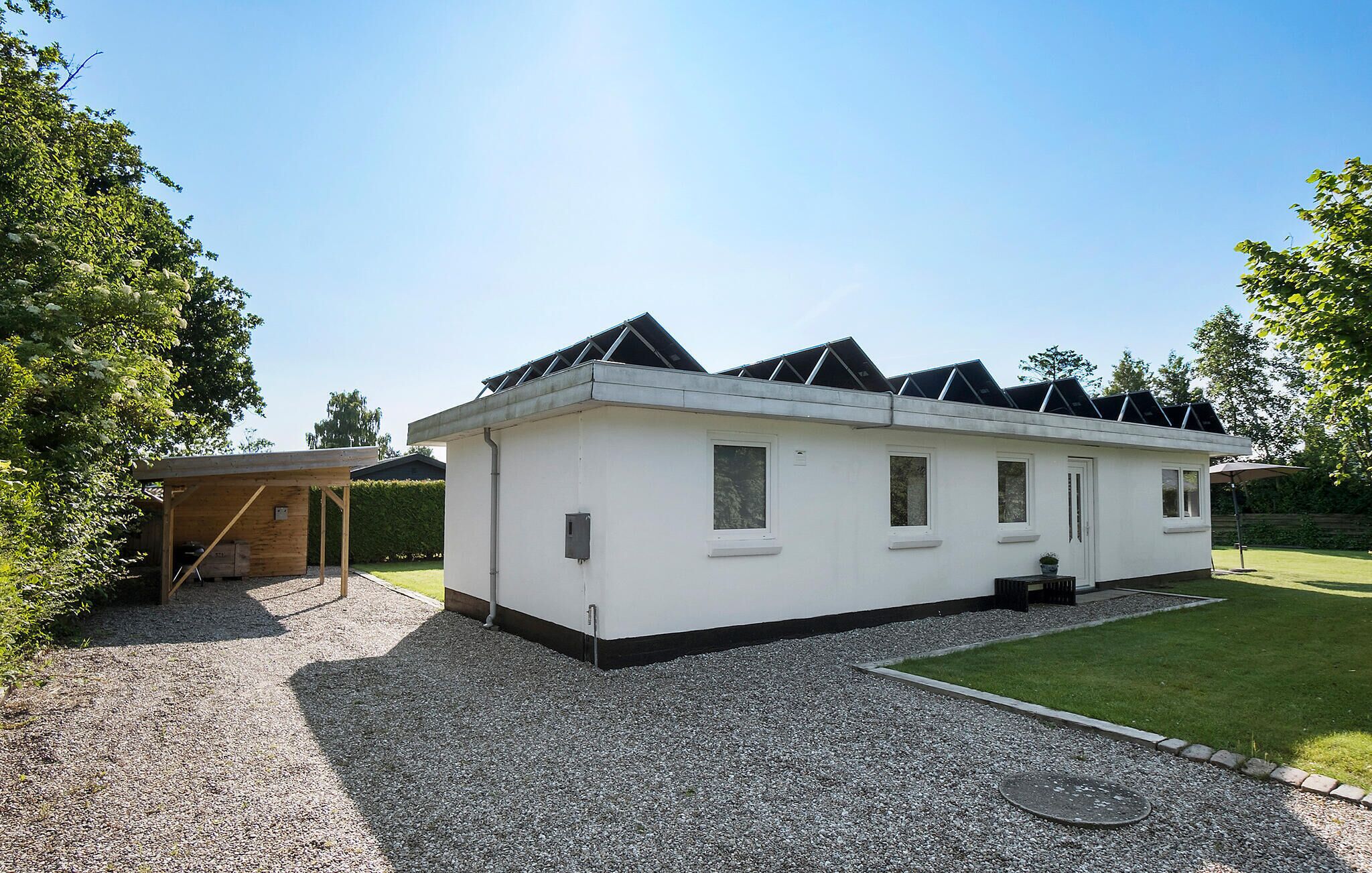 A single-story house with a flat roof and a small attached garage.