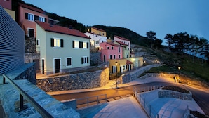 A hillside village with colorful buildings, a stone pathway, and a small bridge. - Awesome home in Magliolo with sauna (Magliolo)