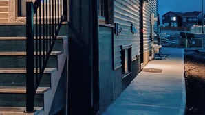 A building with a staircase leading to a door with frosted glass panels. - Luxury Guest Suite in Calgary perfect for a visit to the Canadian Rockies. (Calgary)