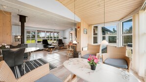 A spacious living area with a large window, a fireplace, and comfortable seating. - Gorgeous home in Tarm with WiFi (Tarm)