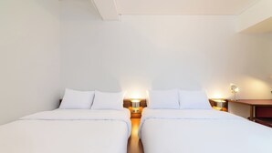 A hotel room with two beds, each with white bedding and nightstands with lamps. - Small House Big Door Myeongdong (Seoul)