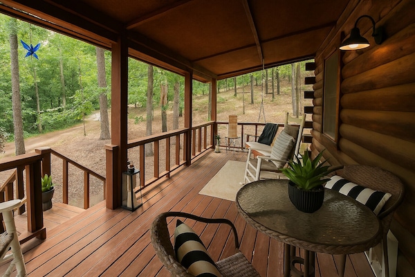 Relax on the screened in porch with plush seating, your go to spot for morning coffee and peaceful moments in Eureka Springs.