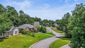 A suburban neighborhood with houses, green lawns, and a curved road. - Save Big! Kent Terrace - 3br in Alabaster (Alabaster)