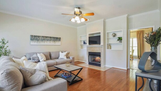 A living room with a fireplace, a sofa set, a coffee table, and a ceiling fan. - Save Big! Kent Terrace - 3br in Alabaster (Alabaster)