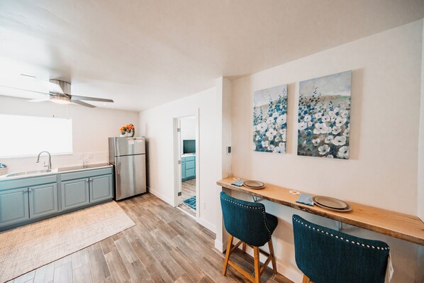 Fridge, stovetop, dishwasher, coffee/tea maker