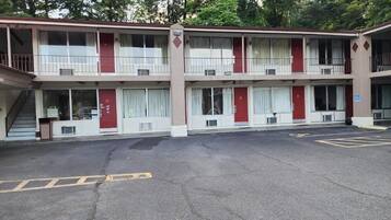 A two-story motel with a parking lot in front.