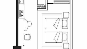 Een plattegrond van een studio-appartement genaamd 'Studio Premier' met een kitchenette, een badkamer, een eetgedeelte en een woongedeelte.