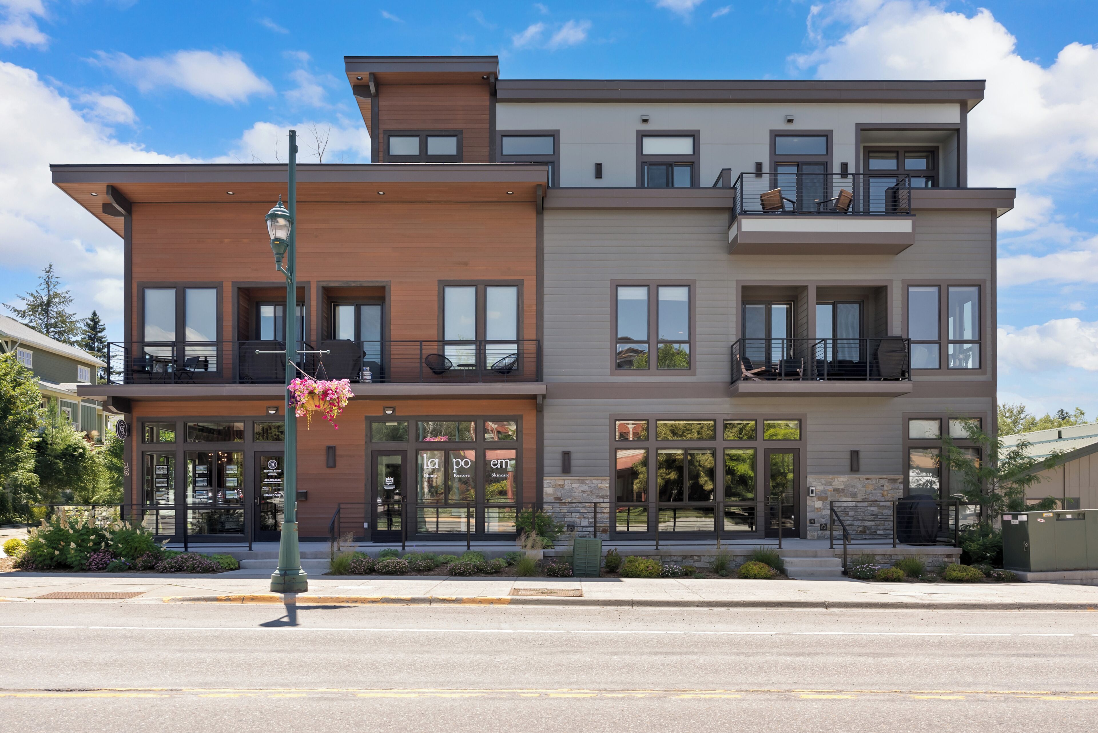 A modern multi-story building with large windows and balconies.
