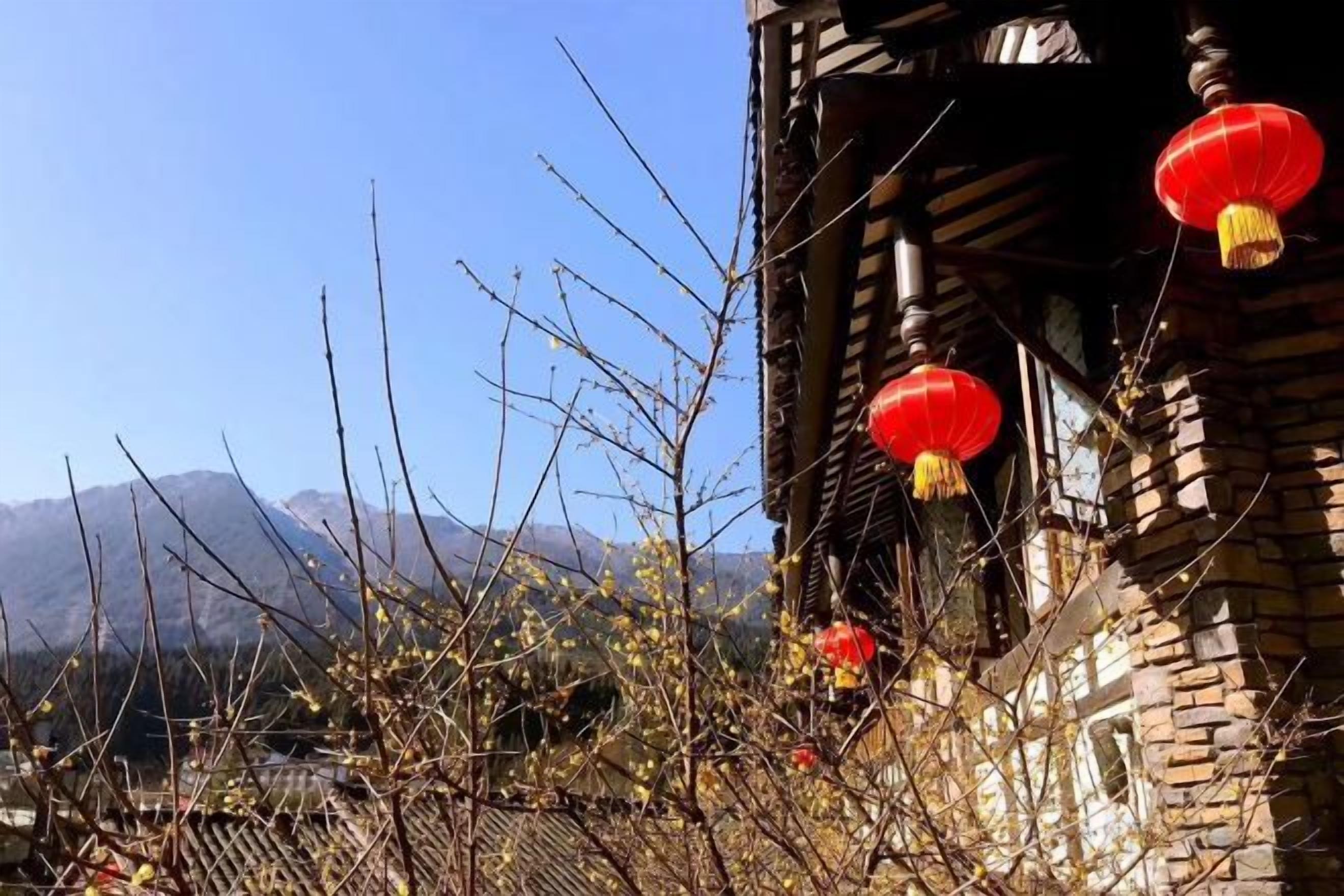 A traditional building with wooden architecture and red lanterns.