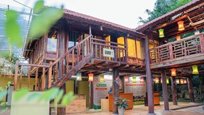 A wooden building with a sign reading "DORM 1". - Golden Mountain Hostel  (Ninh Binh)