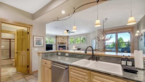 A modern kitchen with granite countertops, stainless steel appliances, and pendant lighting. - Walk to Main Street | Hot Tub, Gym and Game Room (Breckenridge)