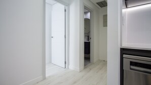 A modern kitchen with white cabinetry and a stainless steel dishwasher.