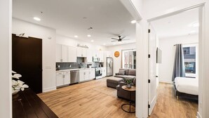 A modern apartment with a kitchen, living area, and a balcony.