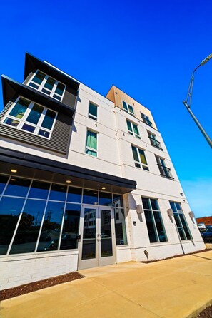 A multi-story building with a flat facade, large windows, and a visible entrance.