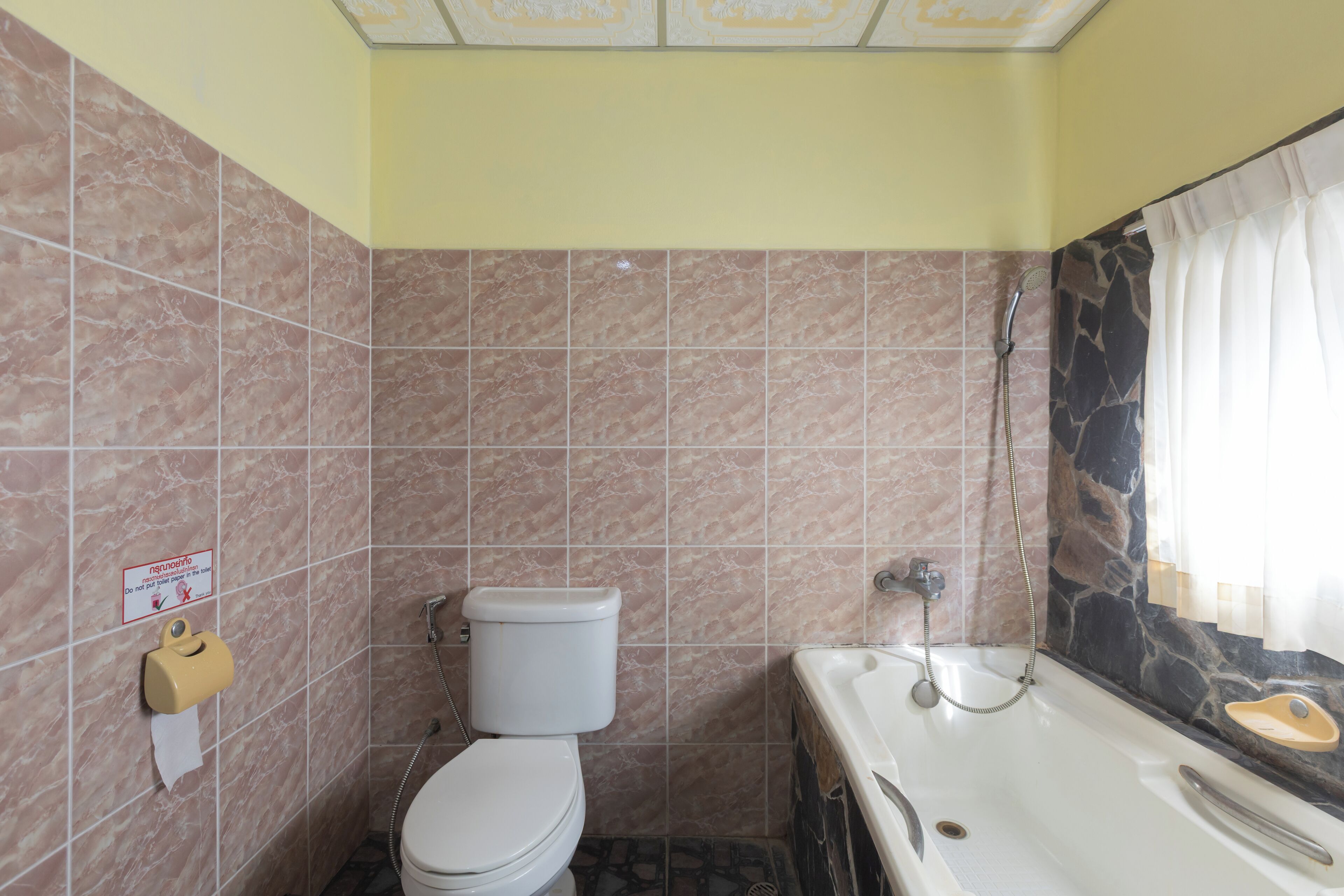 A bathroom with a toilet, a sink, and a shower.