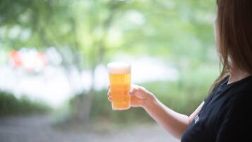 A person holding a glass of beer.