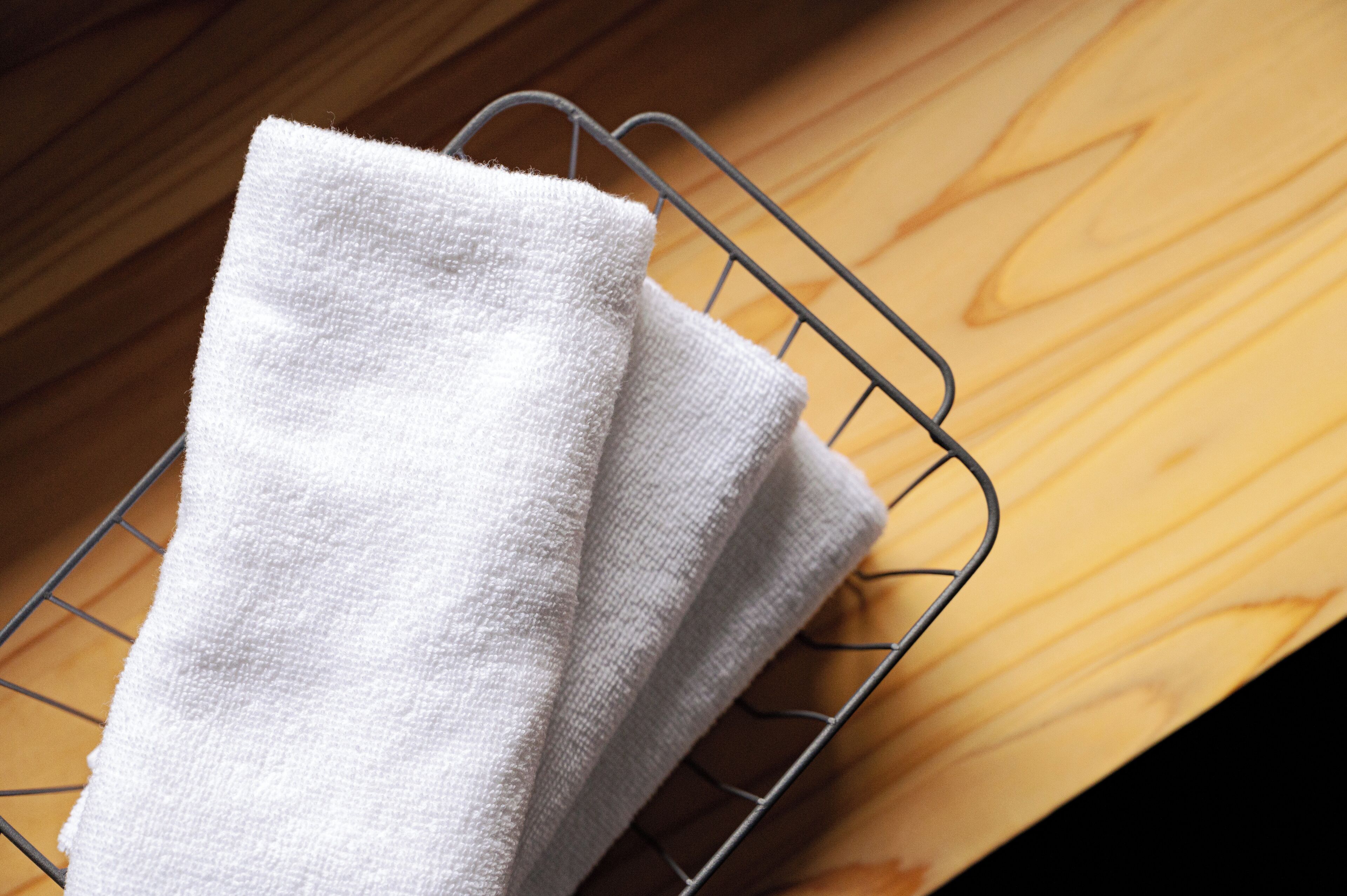A white towel on a metal rack.
