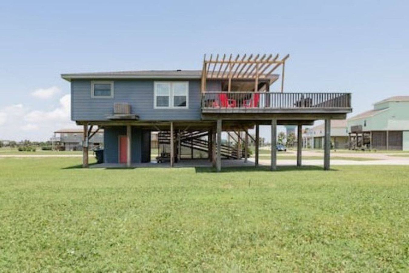 A two-story house with a balcony and a covered outdoor area.