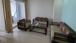 A living room with a sofa set, a coffee table, and a ceiling fan. - YMCA Training Center and Guest House  (Savar)