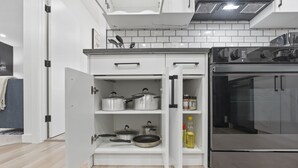 A kitchen with white cabinets, a stainless steel oven, and a built-in microwave.