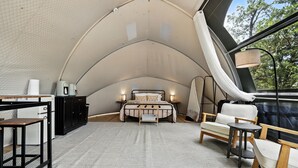 A tented room with a bed, a desk, a chair, and a table. - Escape to Cloud Nine Glamping in the Black Hills (Hermosa)
