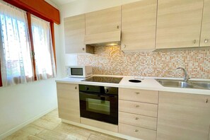 Fridge, microwave, stovetop, dining tables