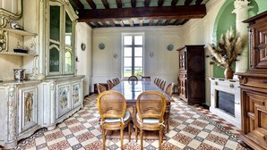 A dining room with a large table, two chairs, and ornate cabinets. - Live the Chateau Dream in the Loire Countryside (Bazouges-sur-le-Loir)