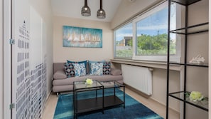 A modern living room with a sofa, coffee table, and artwork.