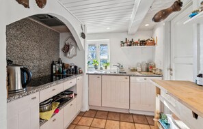 Fridge, dishwasher, coffee/tea maker, cookware/dishes/utensils