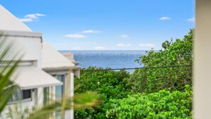 A view of a coastal area with a building in the foreground and the ocean in the background. - Shelly Vista - Beach Days and Poolside Afternoons (East Ballina)