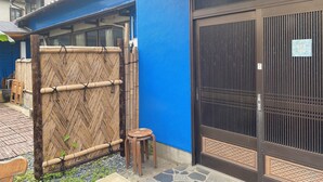 A traditional Japanese building with a blue exterior wall, a bamboo screen, and a black gate. - BeachHouseNumazu (Numazu)
