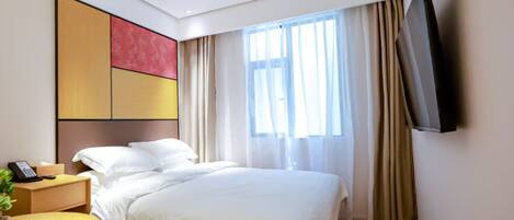 A hotel room with a bed, bedside table, and a TV mounted on the wall.