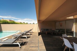 A poolside area with lounge chairs and a wooden deck. - 4BR Villa w/ Private Pool | Salgados | DA’Home (Guia)