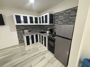 Fridge, microwave, stovetop, coffee/tea maker