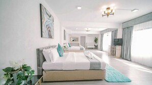 A modern hotel room with a large bed, a desk, and a TV. - Alta Terra Hotel Tagaytay (Tagaytay)