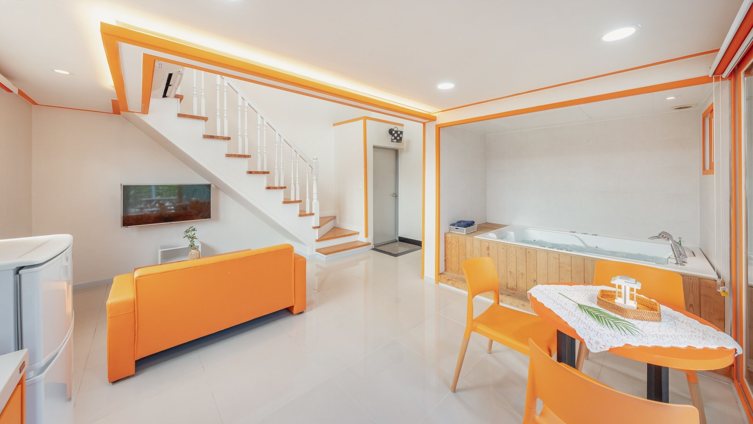 A modern kitchen with a large island, a built-in oven, and a sink.
