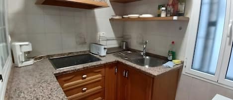 Fridge, microwave, coffee/tea maker, cookware/dishes/utensils