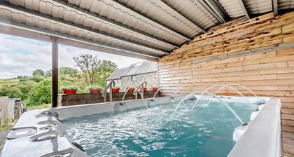 Luxury renovated barn with a large hot tub and games room. Located in the beautiful Welsh countryside with stunning scenery and great hiking trails. Pet and family friendly.