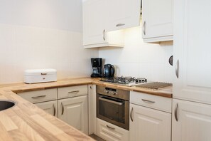 Fridge, dishwasher, coffee/tea maker, dining tables