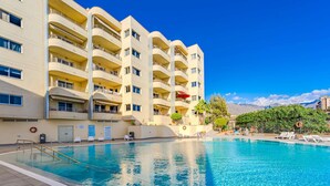 A multi-story hotel with a pool area. - Sol Paraiso 2 bedrooms apartment (Adeje)