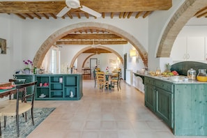 A spacious kitchen with a central island, wooden beams, and arched ceilings. - Relaxing Family Podere Delle Rose Pool & Garden (Civitella Paganico)