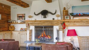 A cozy living room with a fireplace, wooden beams, and rustic decor. - Lovely apartment in villa for 15 guests with WIFI, hot tub and terrace (Vercorin)