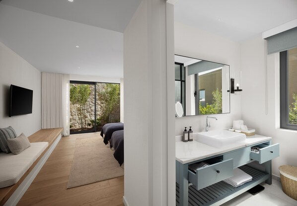 A modern bathroom with a large mirror, white sink, and a window. - Akra Didim Resort & SPA (Didim)