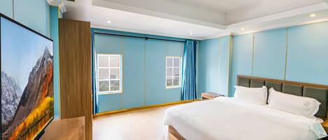 A modern hotel room with a large bed, a flat-screen TV, and a window with curtains.