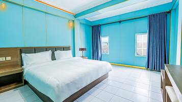 A modern hotel room with a large bed, a bedside table, a nightstand, a window with curtains, and a view of the city.