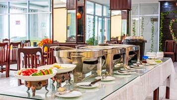 A buffet setup with multiple serving stations and a variety of dishes.