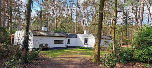 A white house with a tiled roof surrounded by trees. - Vacation home Knabbel & Babbel (Lochem)