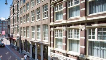 A row of traditional brick buildings with large windows and a clear sky.