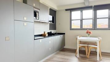 Studio Suite, City View | Private kitchen | Full-size fridge, microwave, stovetop, cookware/dishes/utensils